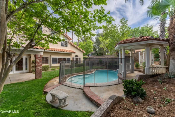 a backyard of a house with yard table and chairs