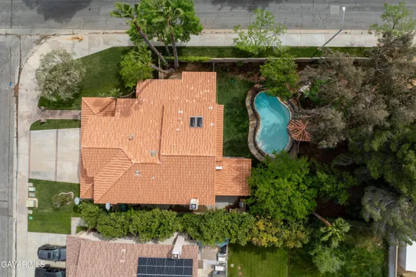 an aerial view of a house with a yard and a garden