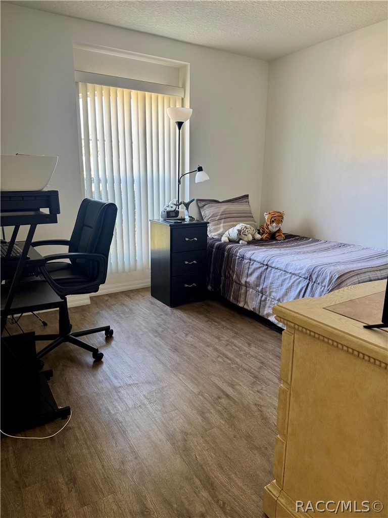 4588 East Van Ness Road Inverness, FL 34453 - Photo 25 of 34 a bedroom with a bed and a desk