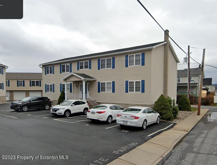 a couple of cars parked in front of a house