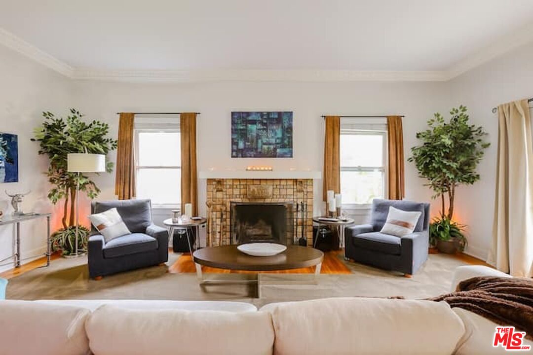 1203 South Rimpau Boulevard Los Angeles, CA 90019 - Photo 2 of 21 a living room with furniture and a fireplace