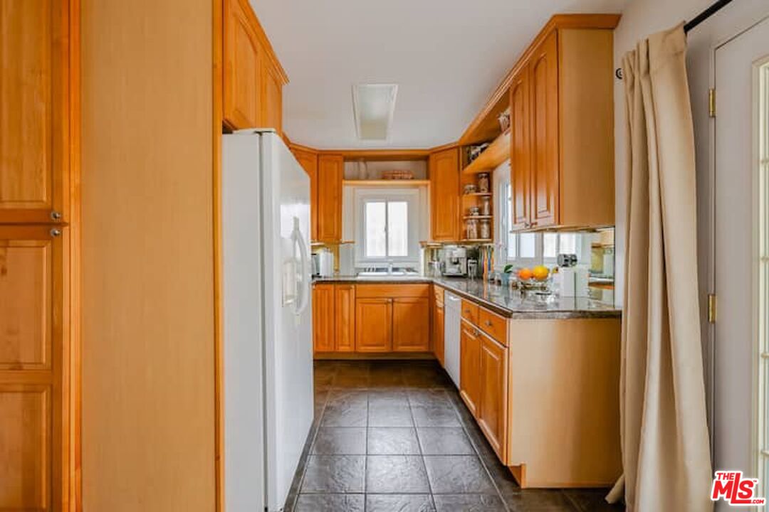 1203 South Rimpau Boulevard Los Angeles, CA 90019 - Photo 5 of 21 a large kitchen with a large window