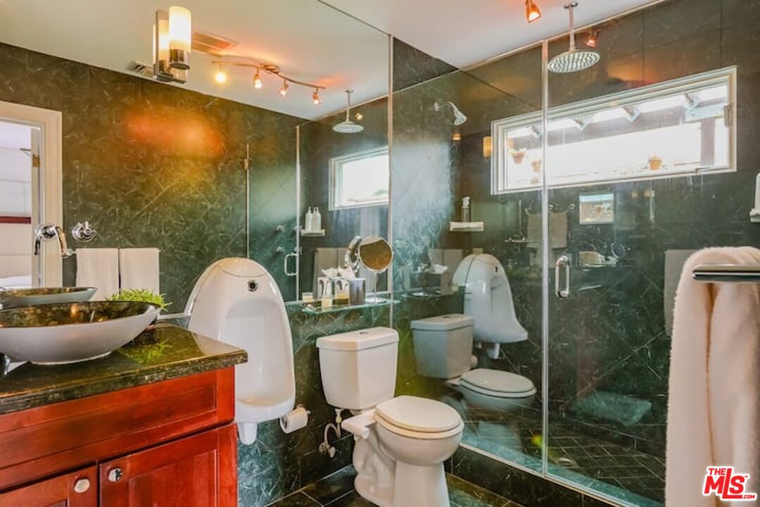 1203 South Rimpau Boulevard Los Angeles, CA 90019 - Photo 9 of 21 a bathroom with a sink mirror toilet and shower