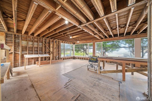 a view of a room with wooden floor and iron stairs