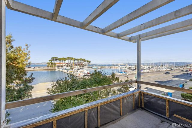 a view of a porch with furniture and a gate