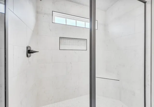 a bathroom with a glass shower door