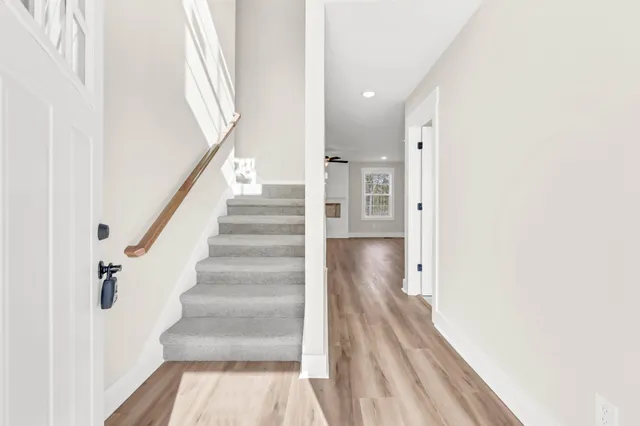 a view of entryway with wooden floor and stairs