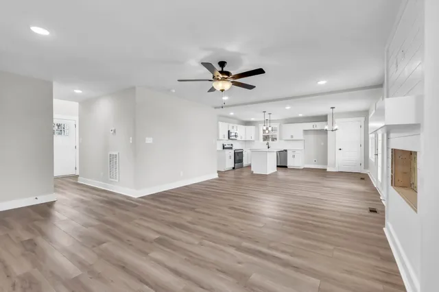 a view of a kitchen with a sink and a refrigerator