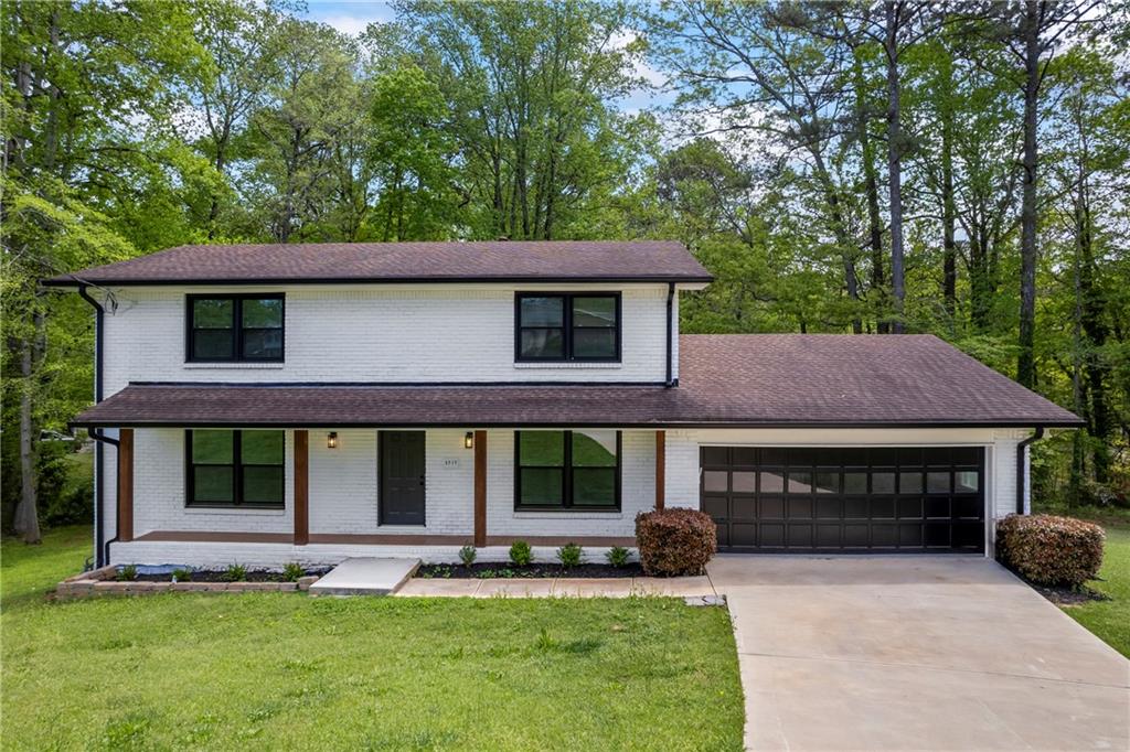 3717 Birchbriar Court Decatur, GA 30034 - Photo 1 of 1 a front view of a house with a yard table and chairs