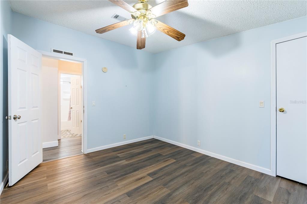 16314 Tiger Trail Spring Hill, FL 34610 - Photo 32 of 43 a view of an empty room with wooden floor