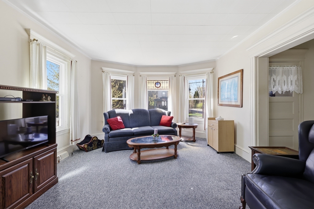 367 Broadway Street, Unit 1 Chicopee, MA 01020 - Photo 2 of 18 a living room with furniture and a fireplace