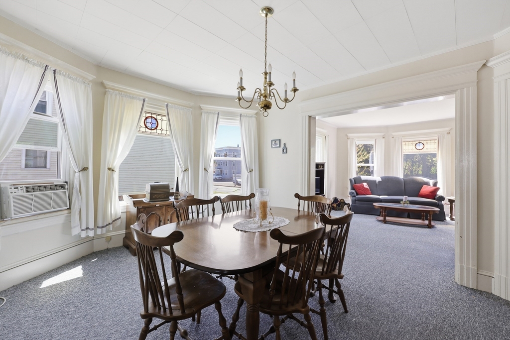 367 Broadway Street, Unit 1 Chicopee, MA 01020 - Photo 7 of 18 a view of a dining room with furniture and a chandelier