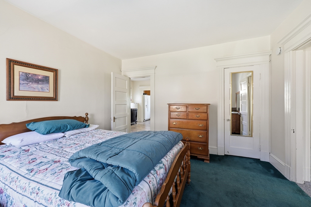 367 Broadway Street, Unit 1 Chicopee, MA 01020 - Photo 9 of 18 a bedroom with a bed and a cabinets