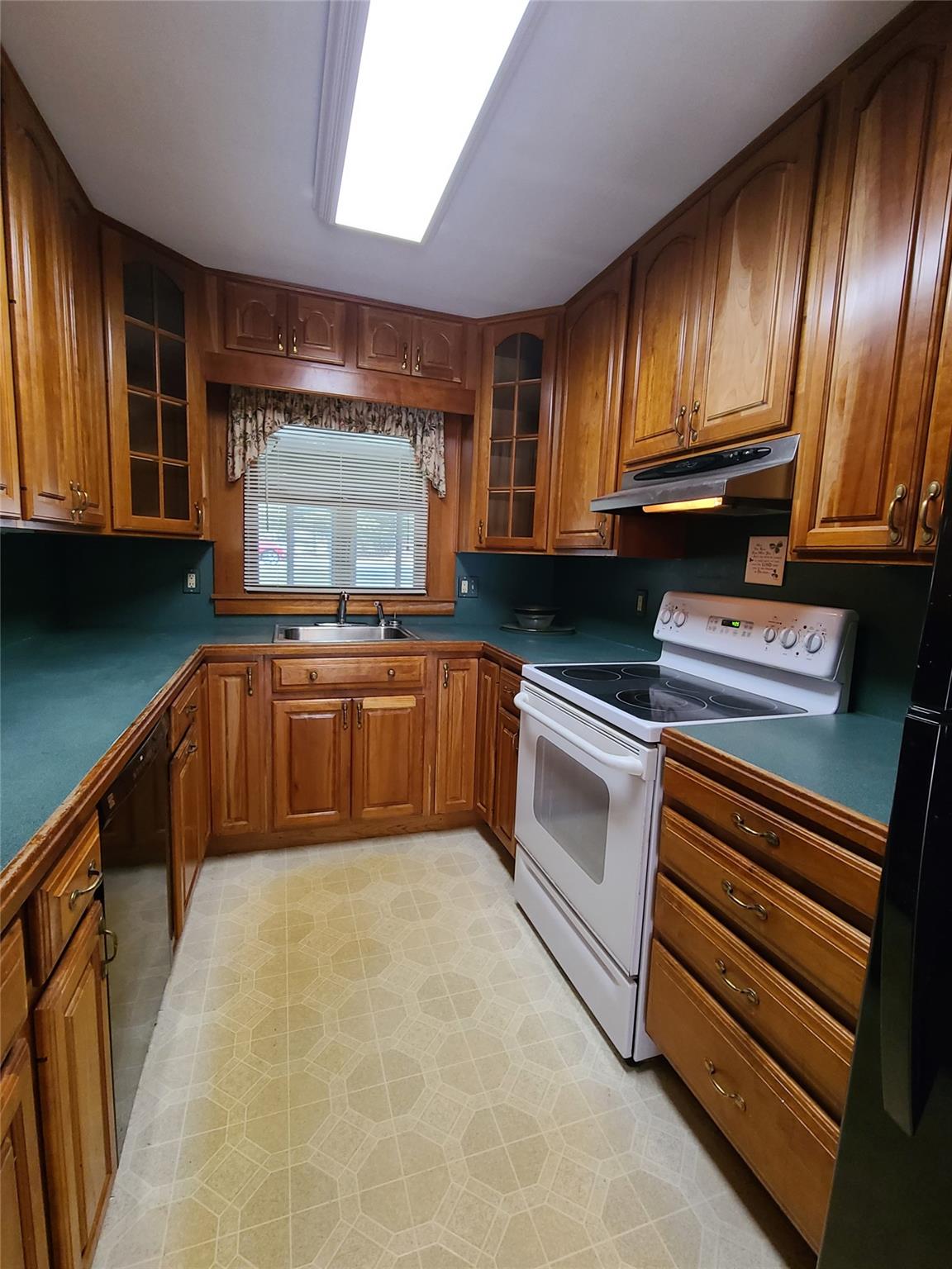 493 Old Taylor Road Jeffersonville, NY 12748 - Photo 14 of 35 a kitchen with granite countertop stainless steel appliances and wooden cabinets