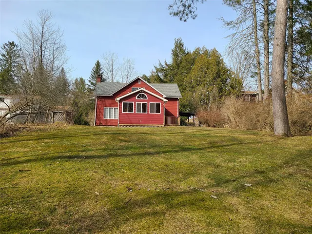 a front view of house with yard and green space