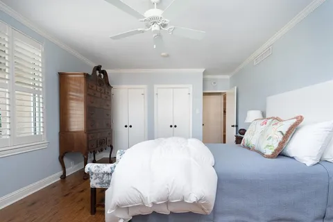 a spacious bedroom with a bed and a window