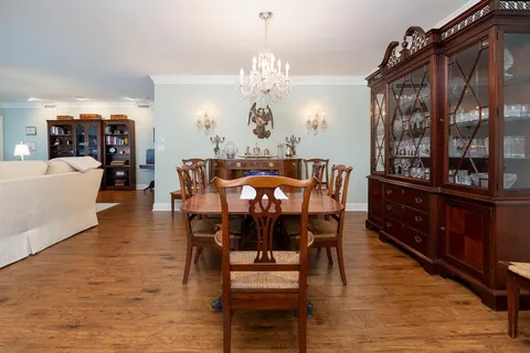 a view of a dining room with furniture and chandelier