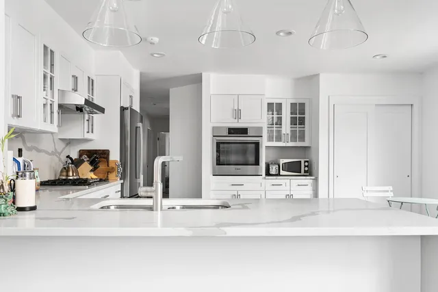 a kitchen with stainless steel appliances kitchen island granite countertop a sink and cabinets