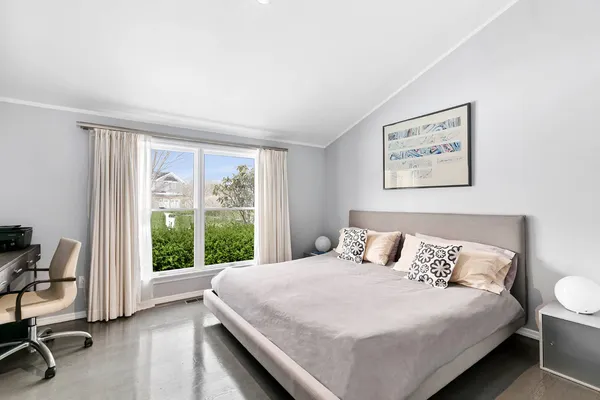 a bedroom with a large bed and a large window