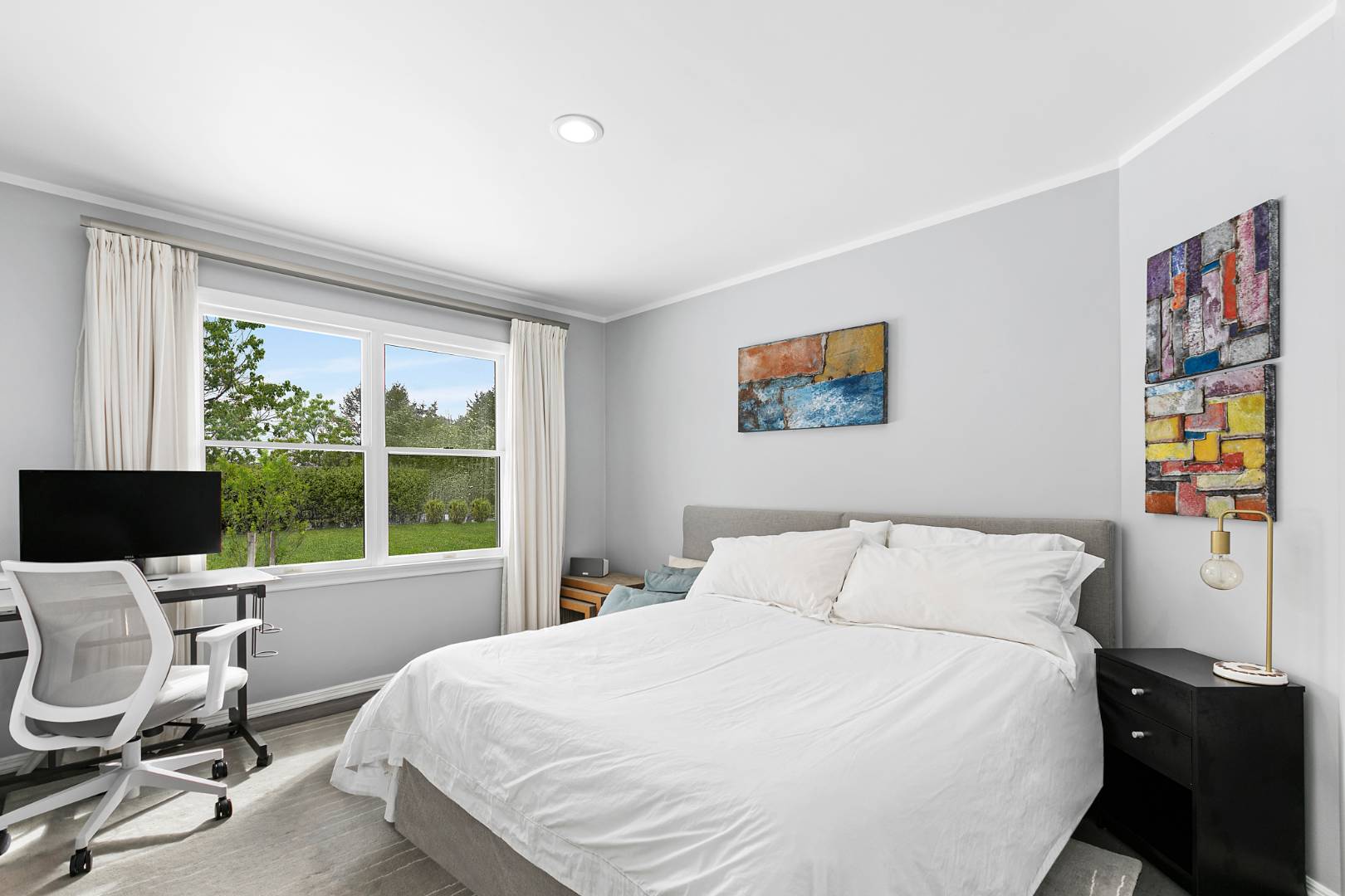 61 Swans Neck Lane Water Mill, NY 11976 - Photo 19 of 33 a bedroom with a bed a computer on the desk and a large window