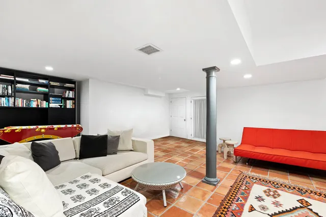 a living room with furniture and a rug