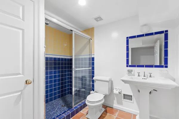 a bathroom with a sink mirror toilet and shower