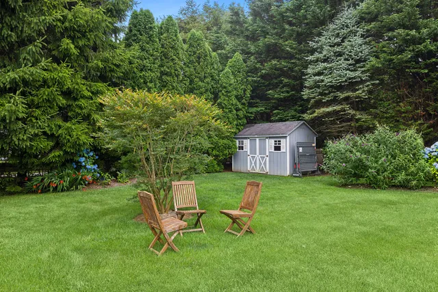 a view of a backyard with chair and a table