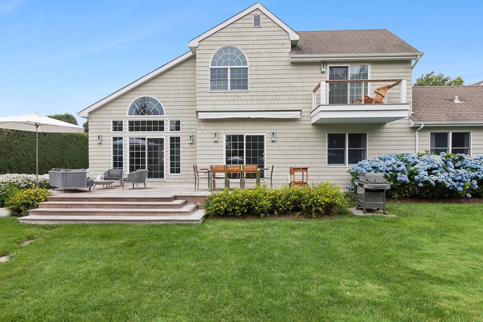 61 Swans Neck Lane Water Mill, NY 11976 - Photo 5 of 33 a front view of a house with a yard