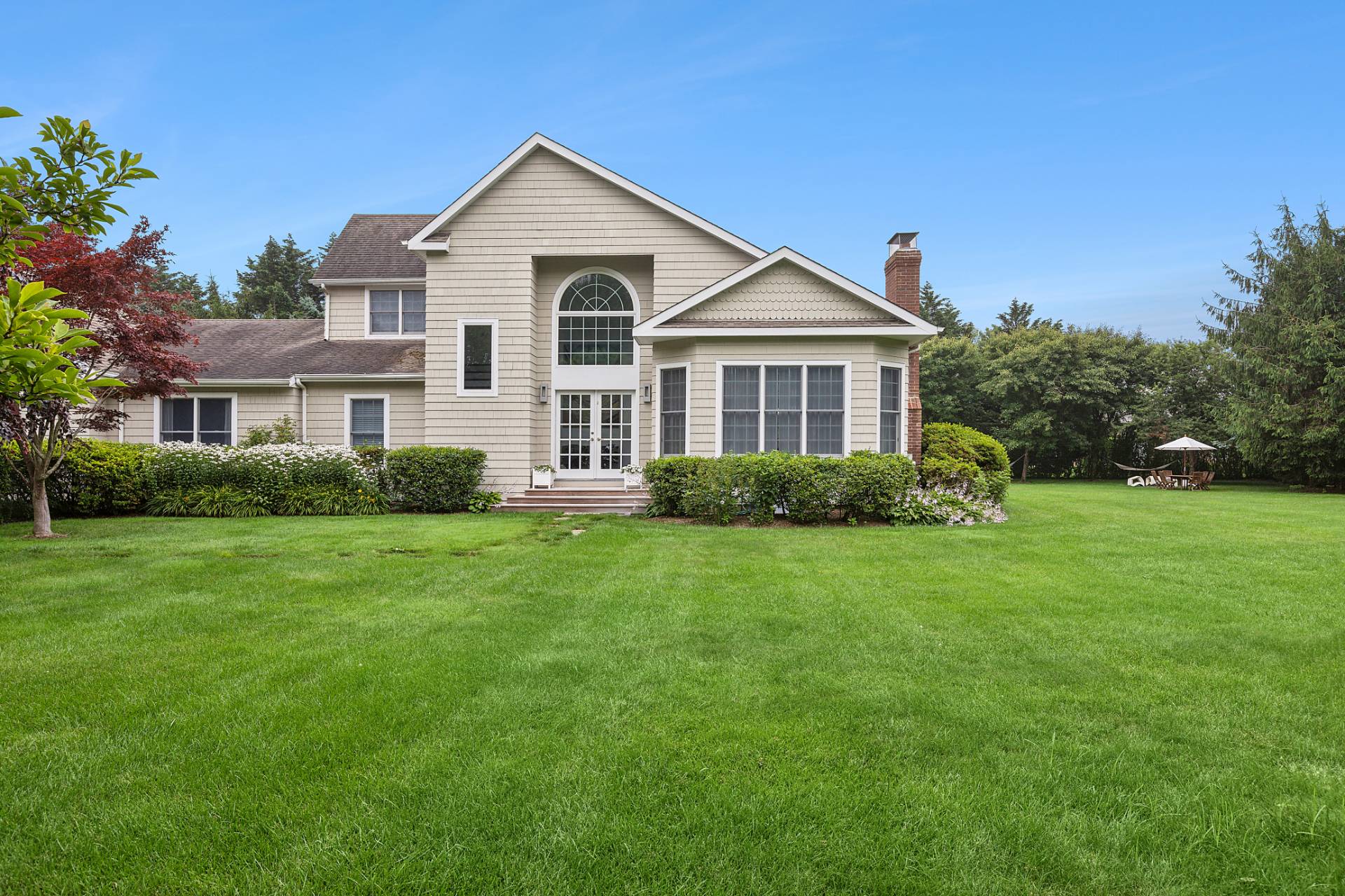 61 Swans Neck Lane Water Mill, NY 11976 - Photo 6 of 33 a front view of a house with a yard