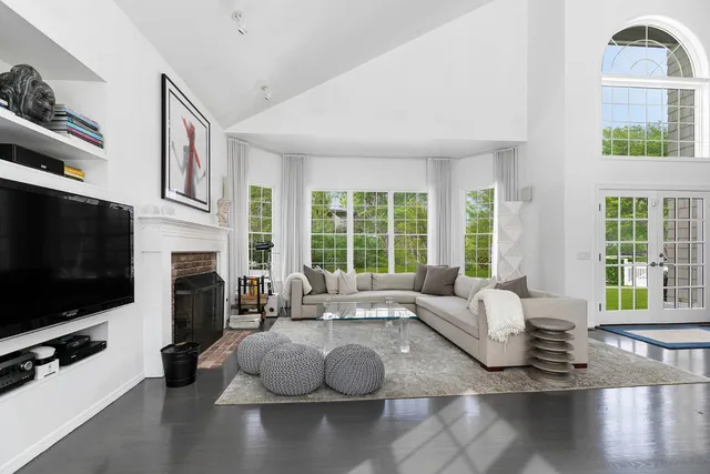 a living room with fireplace furniture and a flat screen tv