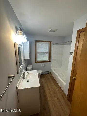 a bathroom with a sink a mirror and a bathtub