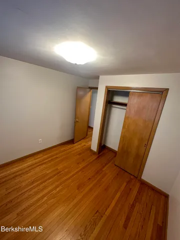 wooden floor in an empty room with a mirror