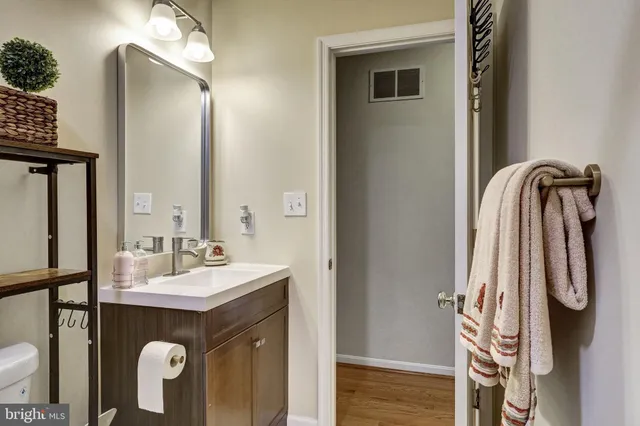 a bathroom with a sink vanity and a mirror
