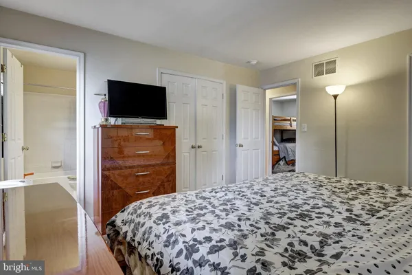 a bedroom with a bed and a television