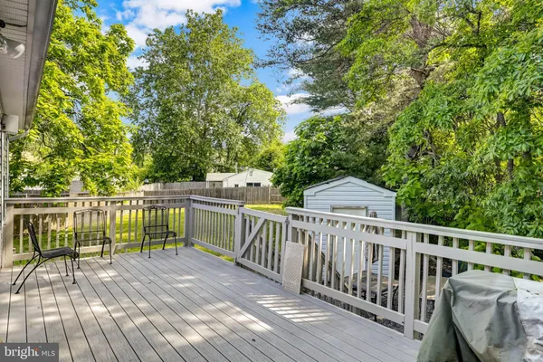 a view of balcony with wooden floor and fence