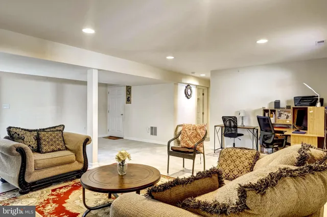 a living room with furniture and a lamp