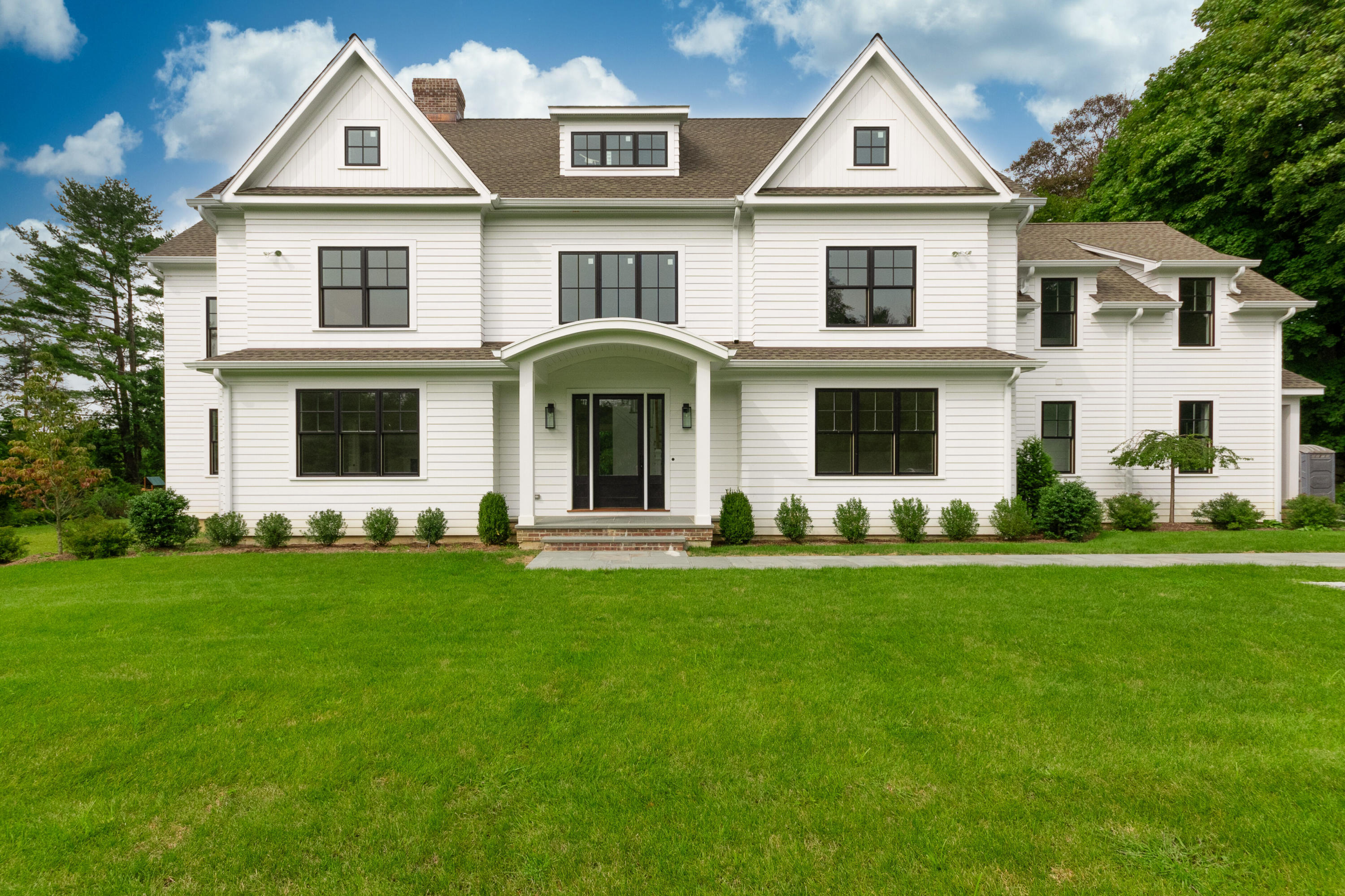a front view of a house with a garden