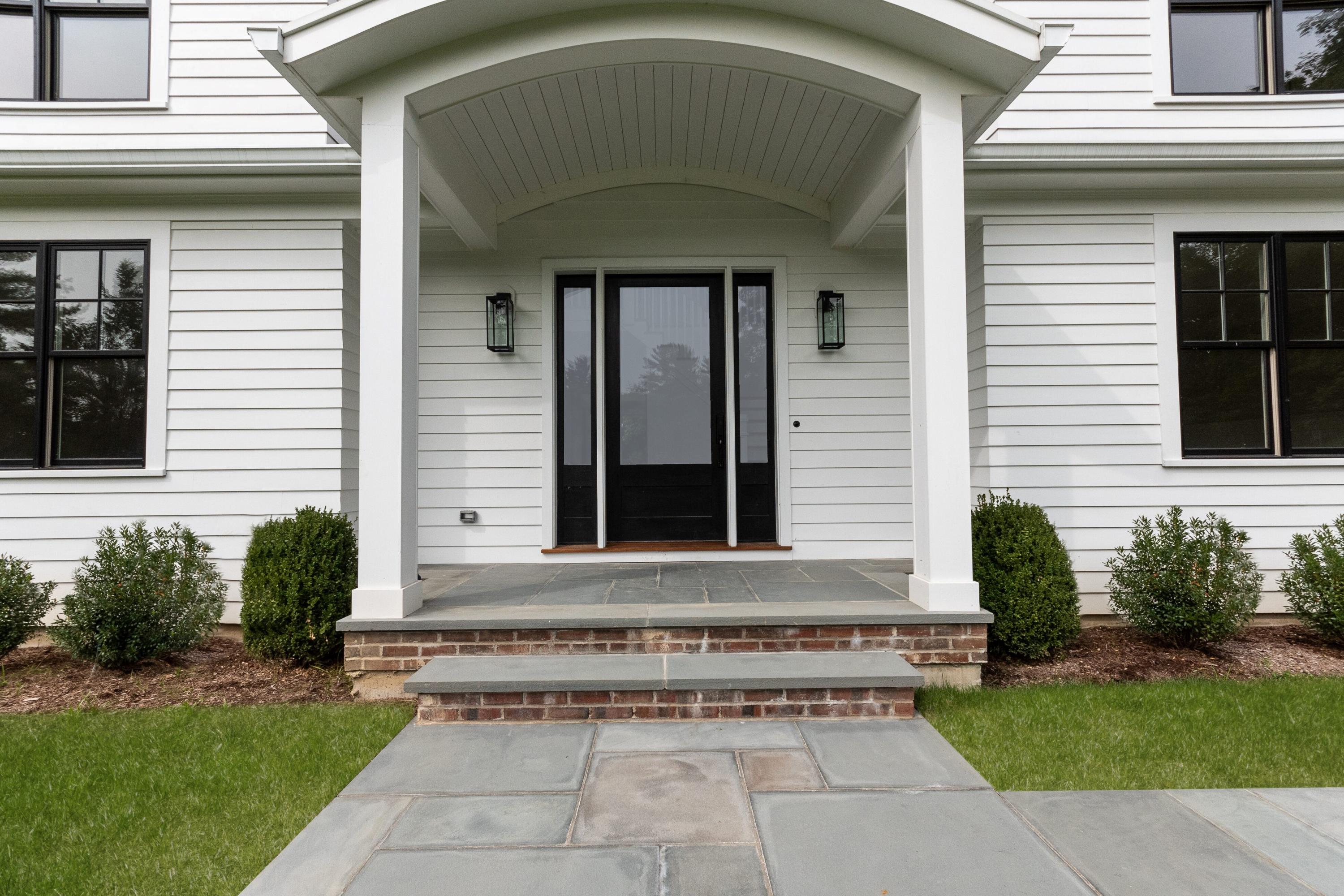 188 Brushy Ridge Road New Canaan, CT 06840 - Photo 2 of 32 a front view of a house with garden