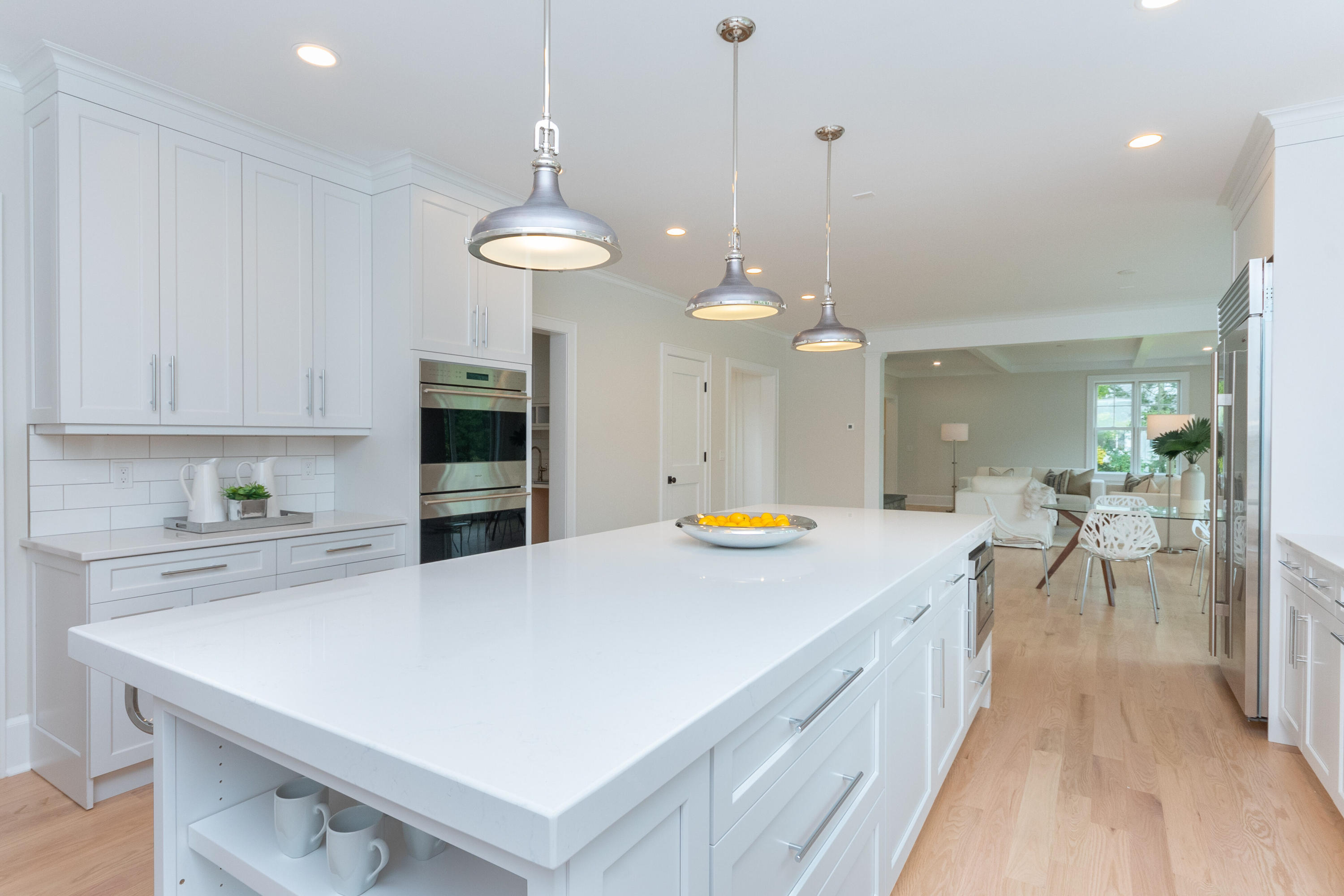 188 Brushy Ridge Road New Canaan, CT 06840 - Photo 16 of 32 a large kitchen with counter top space a sink appliances and living room view