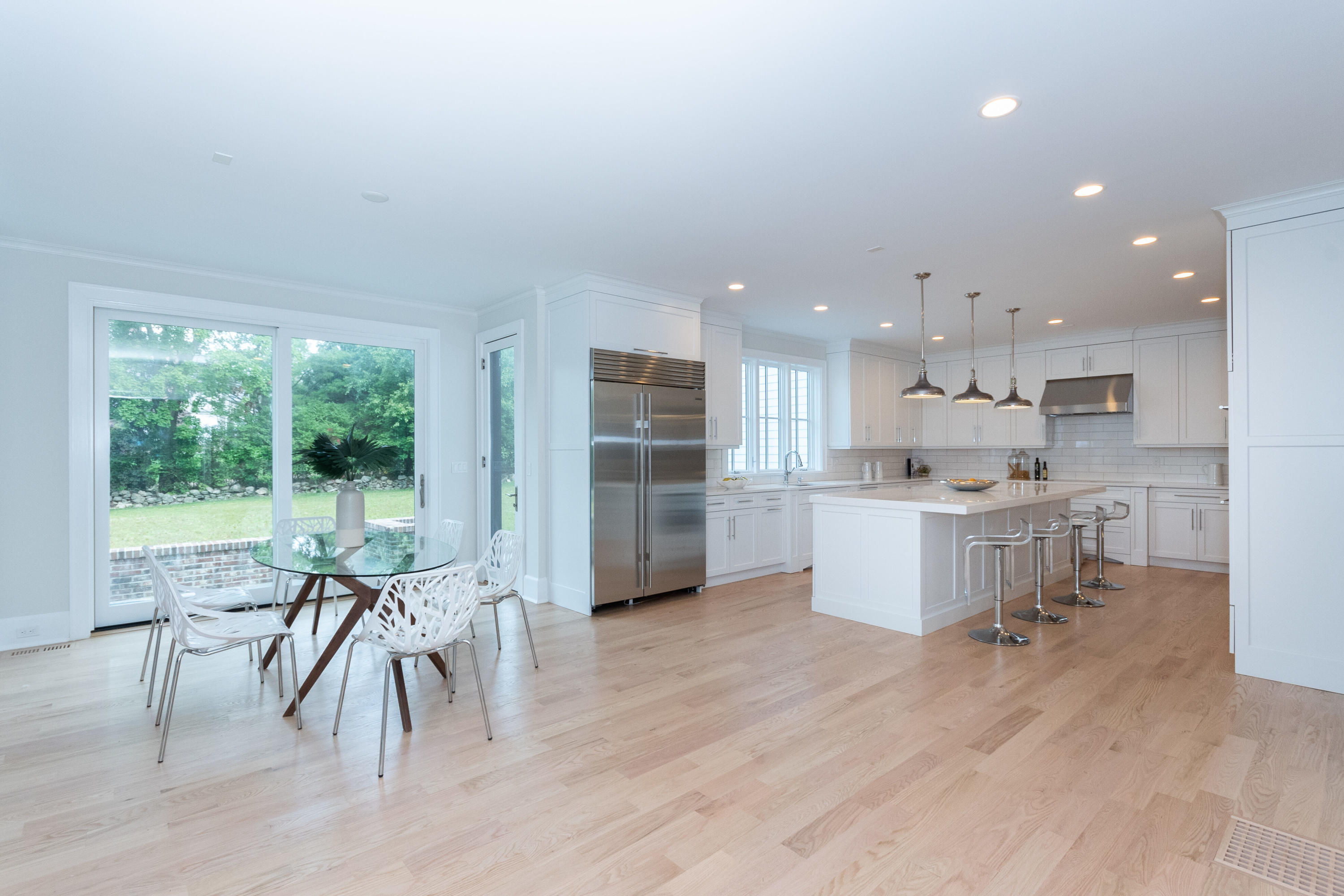 188 Brushy Ridge Road New Canaan, CT 06840 - Photo 17 of 32 a kitchen with a table and chairs in it