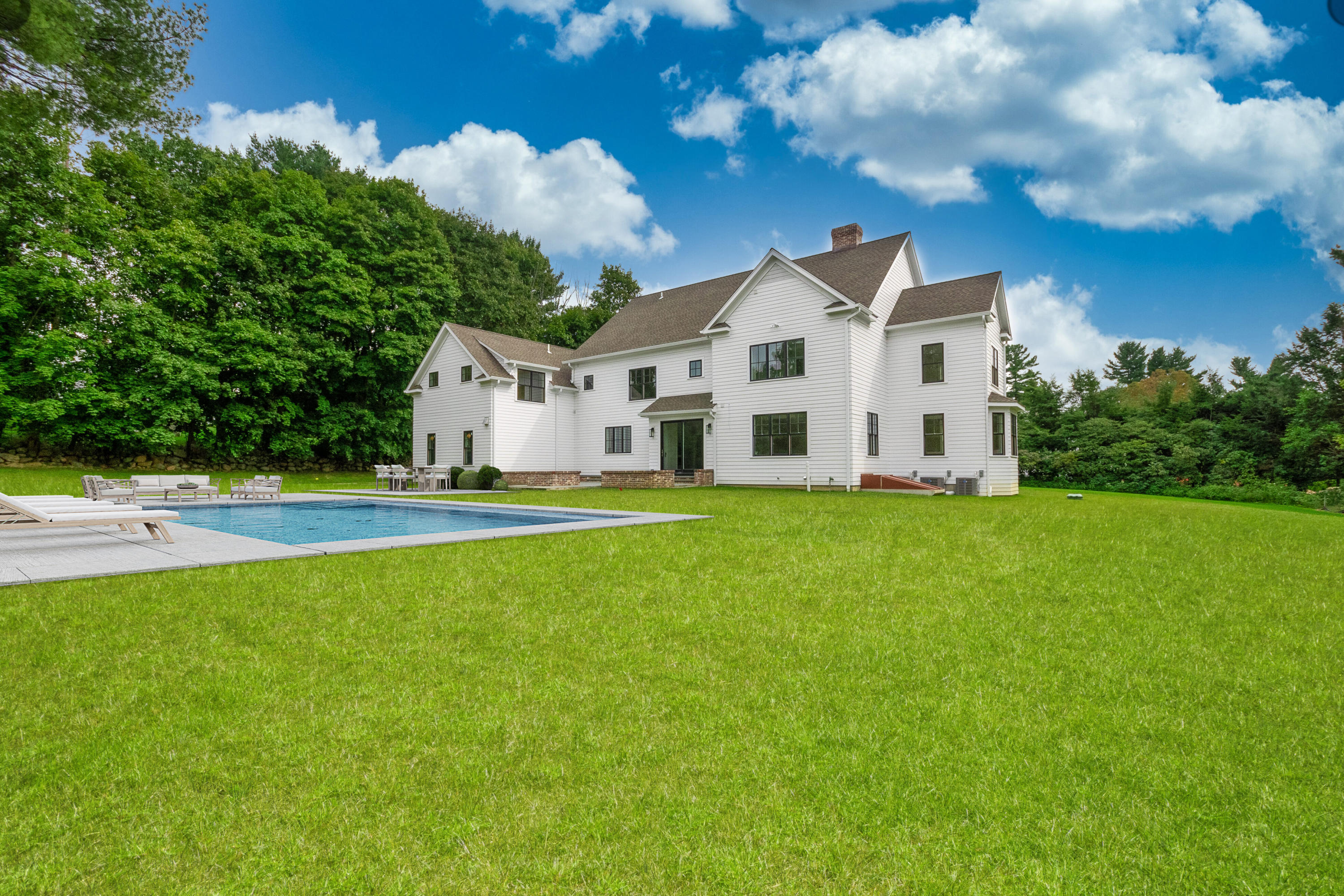 188 Brushy Ridge Road New Canaan, CT 06840 - Photo 27 of 32 a front view of a house with a yard