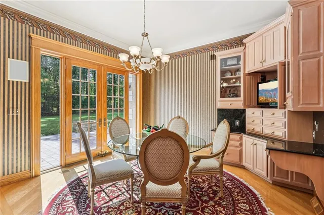 a living room with furniture a chandelier and a rug