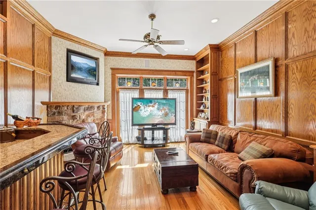 a living room with furniture a chandelier and a flat screen tv