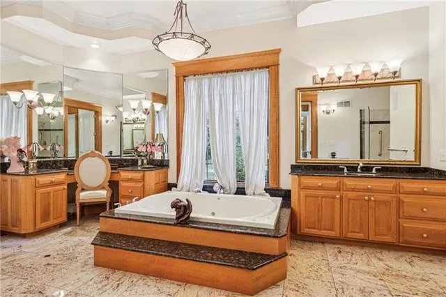 a living room with furniture a large mirror and a chandelier