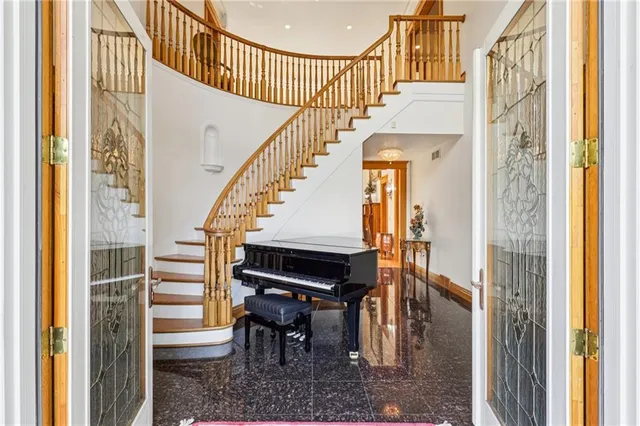 a view of entryway and hall with wooden floor