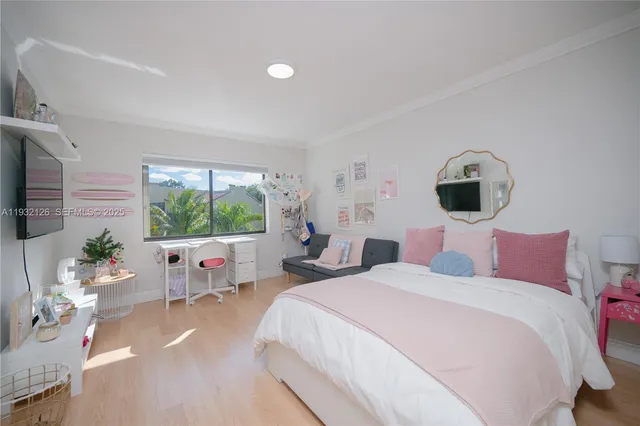 a bedroom with a bed and large windows