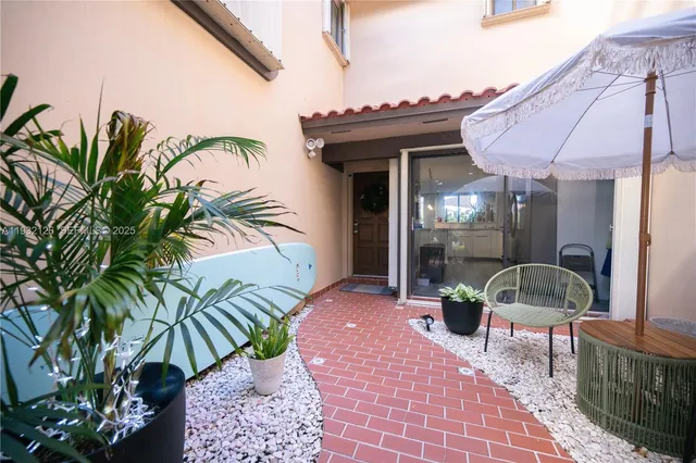 a view of a chairs and table in the patio