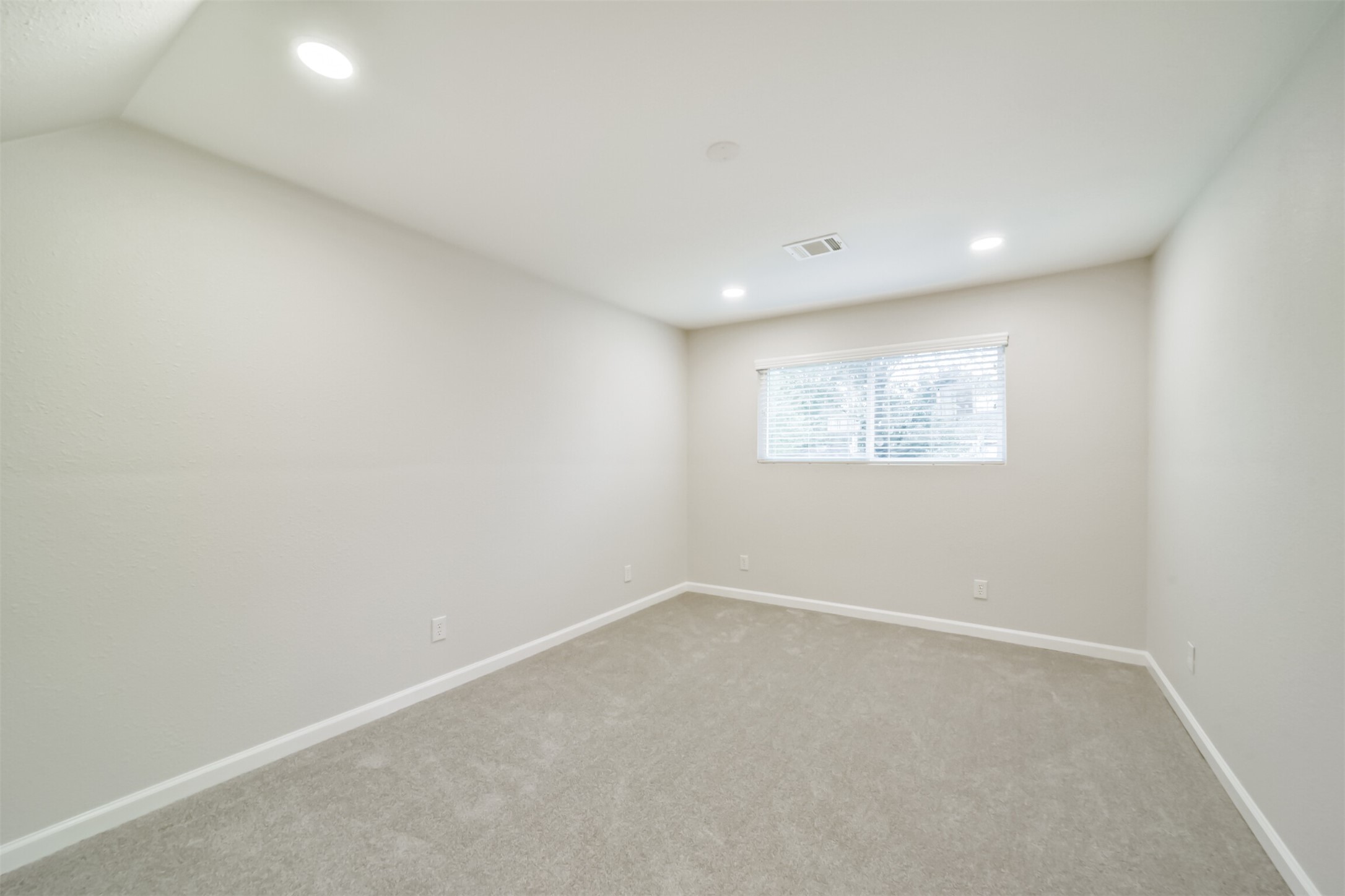 15610 Ripplewind Lane Houston, TX 77068 - Photo 34 of 44 an empty room with a white wall and a window