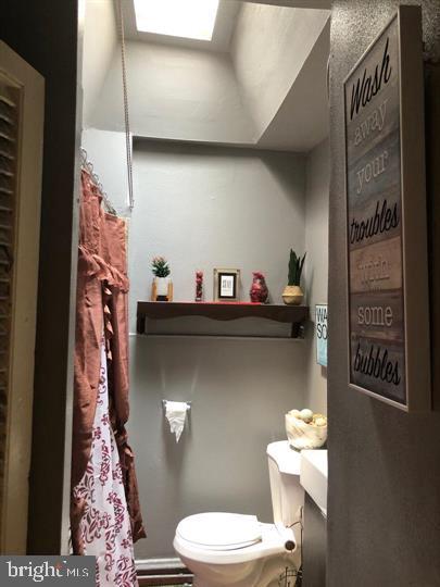 4539 Fernhill Road Philadelphia, PA 19144 - Photo 6 of 10 a bathroom with a toilet sink and mirror