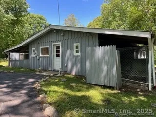 a backyard of a house with barbeque oven
